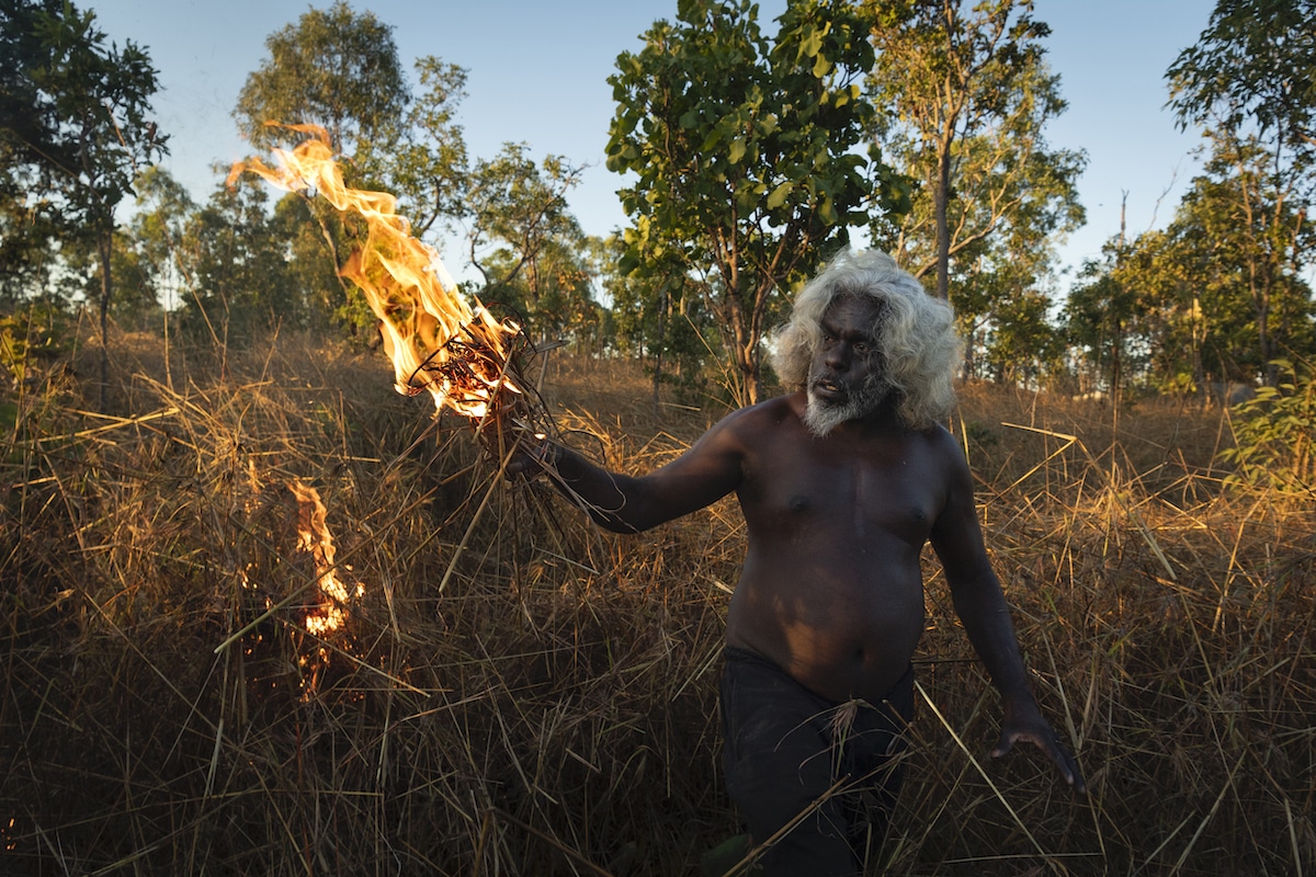 Nawarddeken elder Conrad Maralngurra burns grass to protect the Mamadawerre community from late-season ‘wildfires’