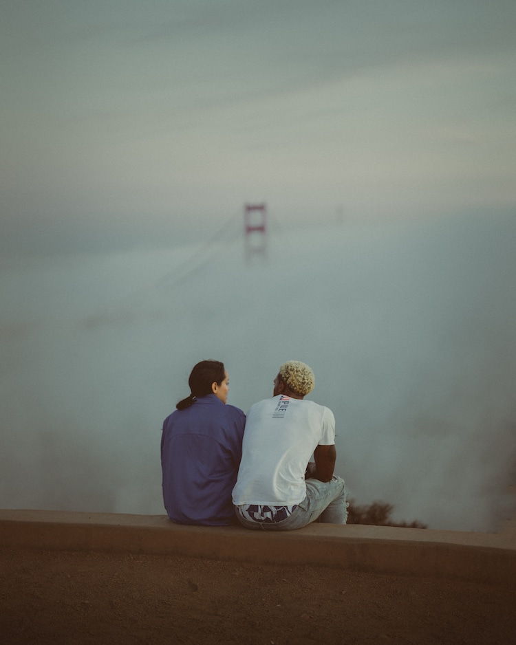 Friends Sitting on Hill Above Golden Gate Bridge