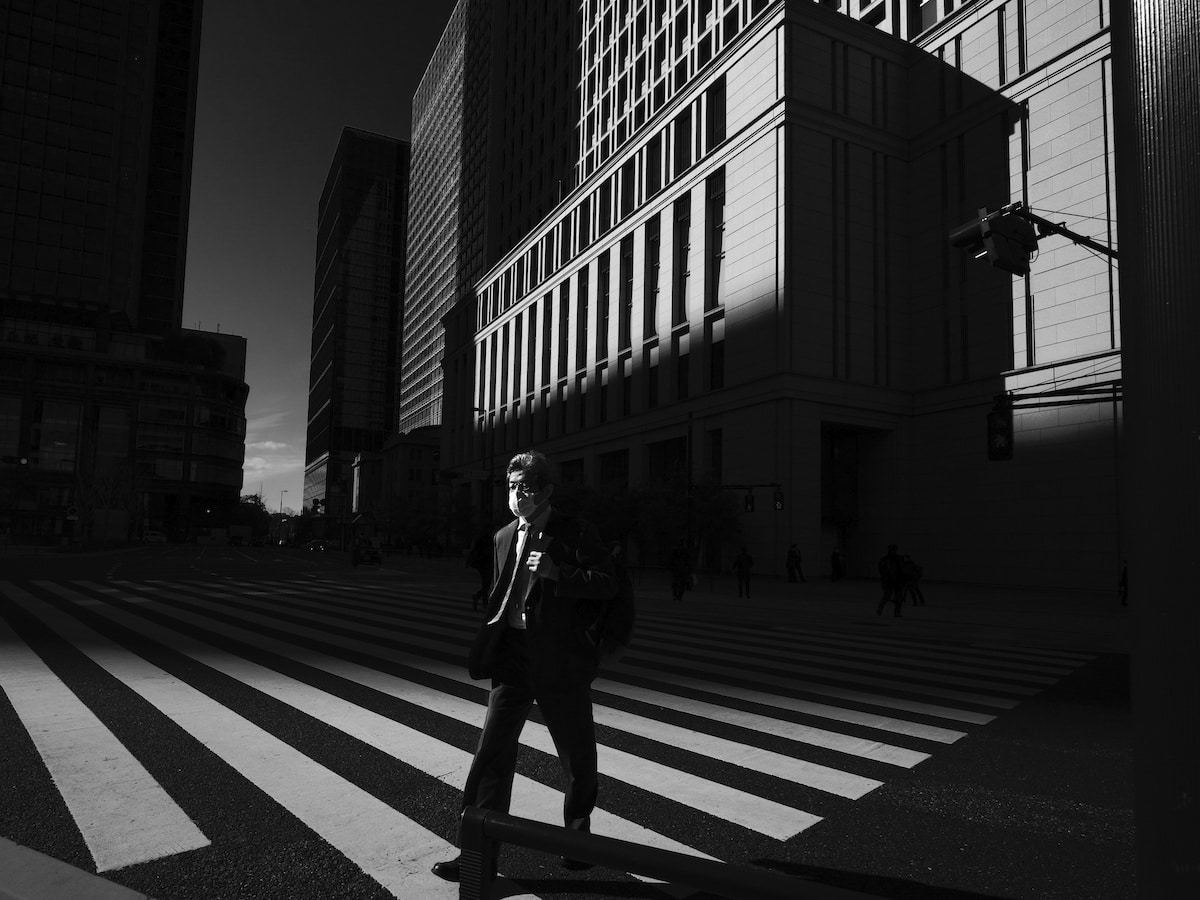 Man Wearing a Mask in Front of Tokyo Station