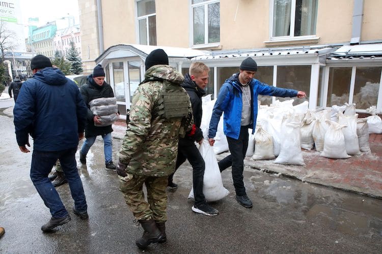 People Carrying Sandbags in Ukraine
