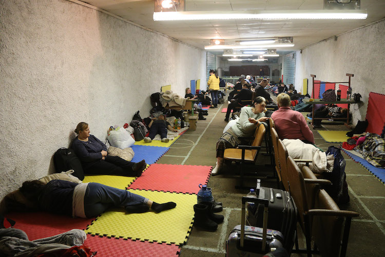 eople sleeping in a shelter at a school in Kyiv