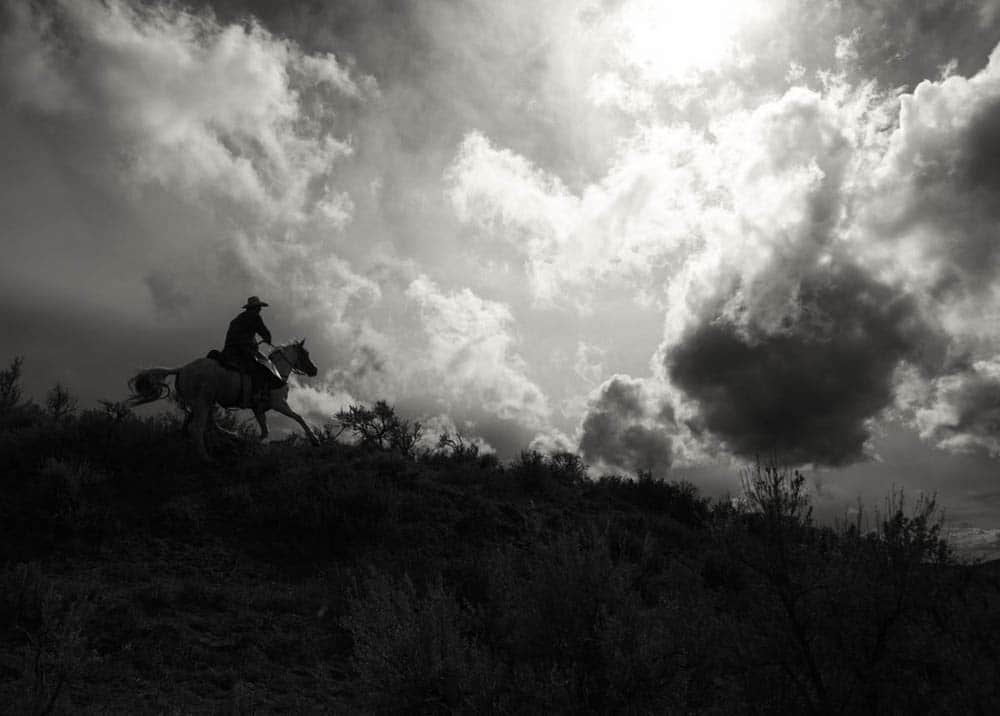 Cowboy on Horseback on a Hill