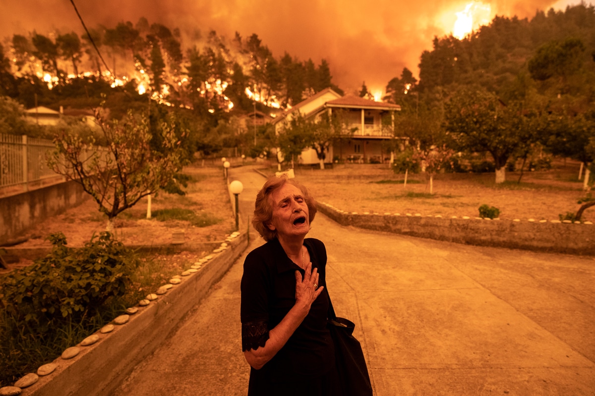 Woman in Distress as a Wildfire in Greece Approaches Her Home