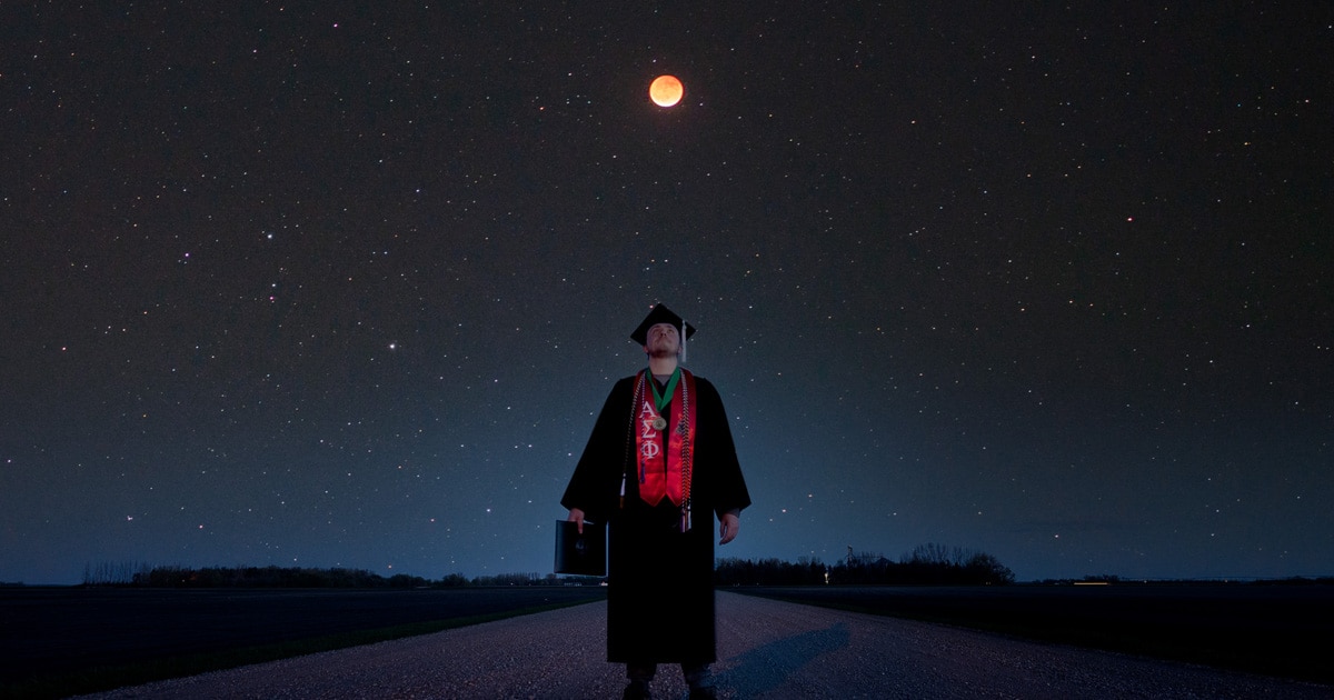Unique Graduation Photo of a Grad Standing Under Lunar Eclipse - My Modern Met