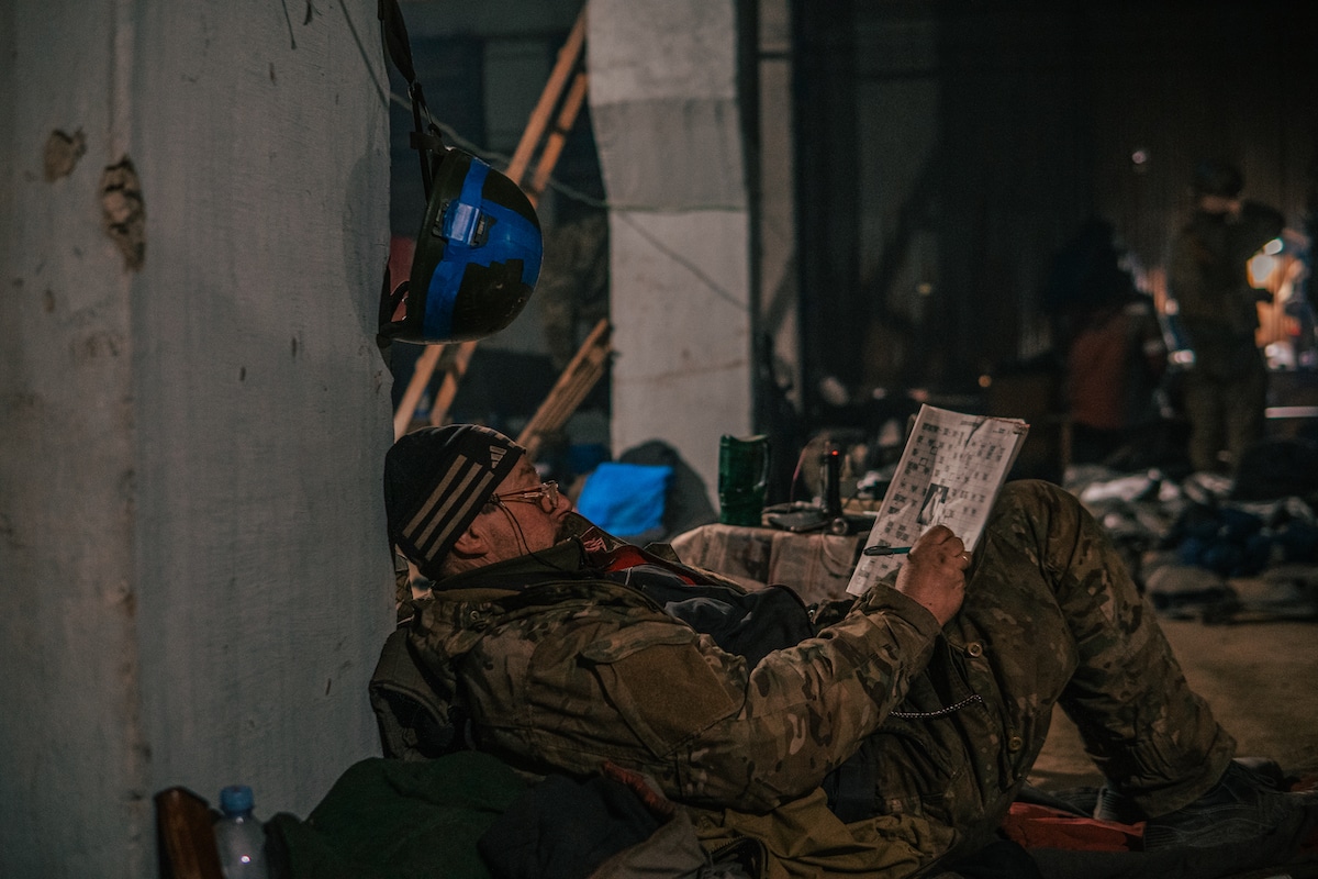 Ukrainian Soldier Doing Crossword Puzzle in Mariupol Steel Factory