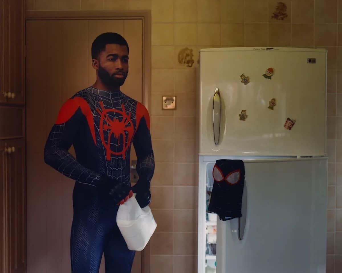 Hombre vestido de Spiderman junto a un refrigerador por Thurstan Redding