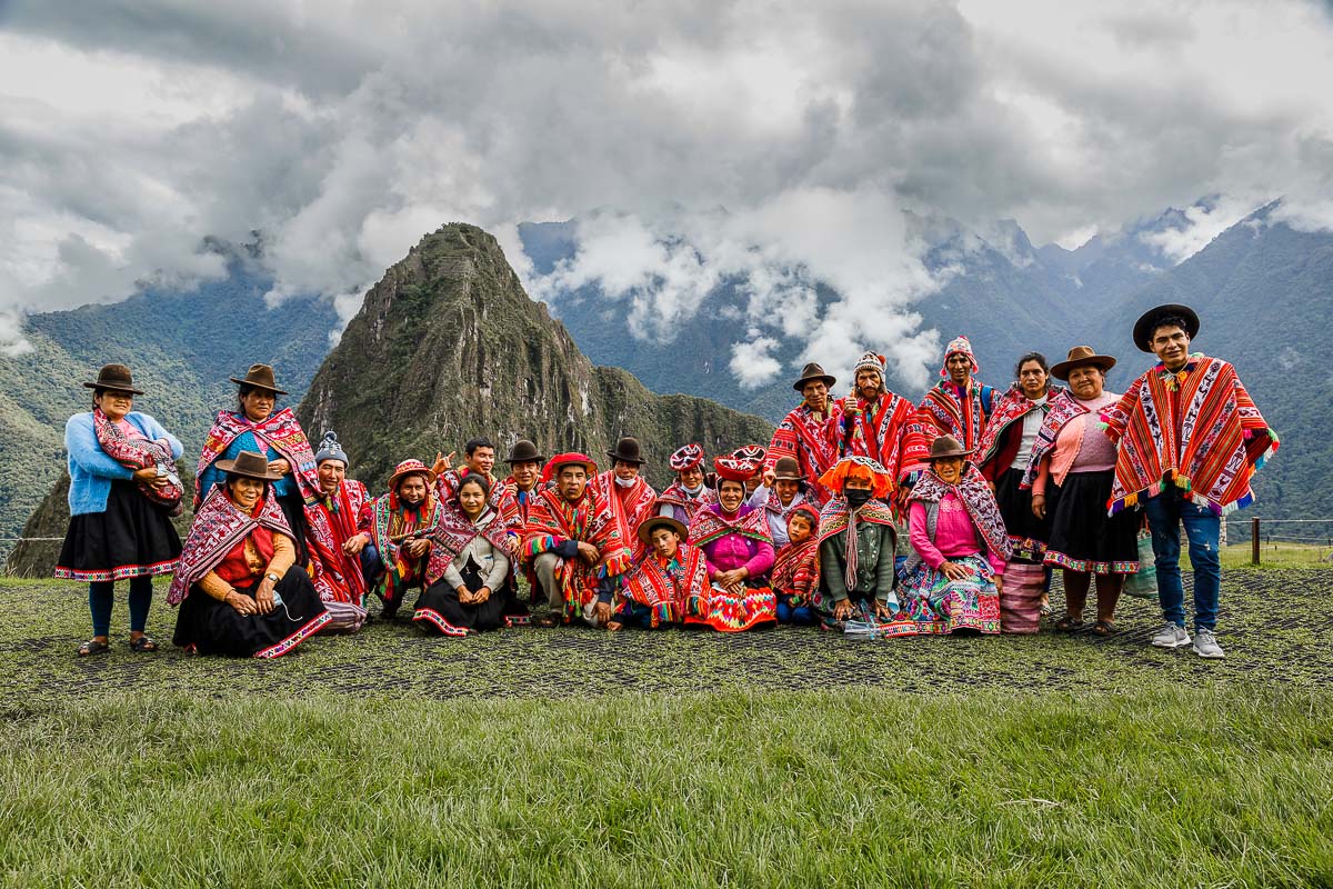 A commemorative group photo with some of the Quechua families while they wait for their individual groups to tour Machu Picchu.