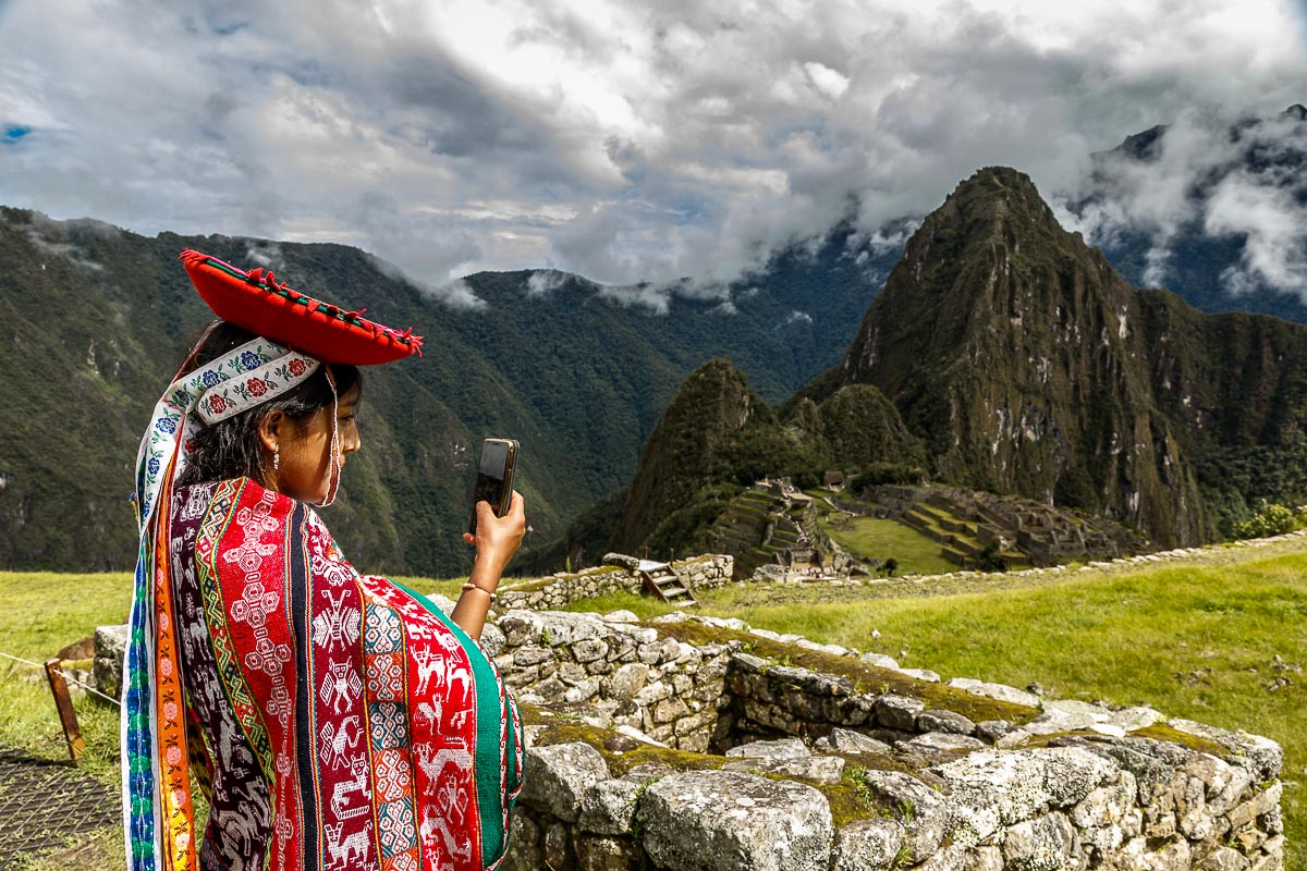 Local Teenage Girl Taking Photo of Machu Picchu