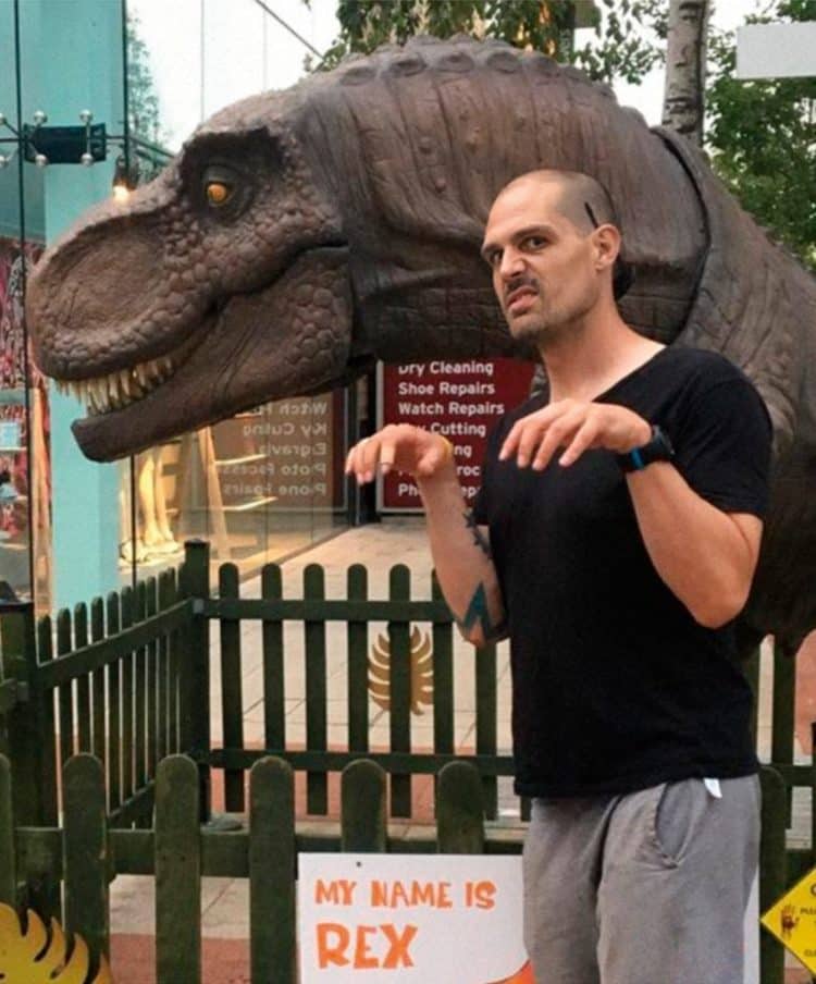Man Posing With a Dinosaur