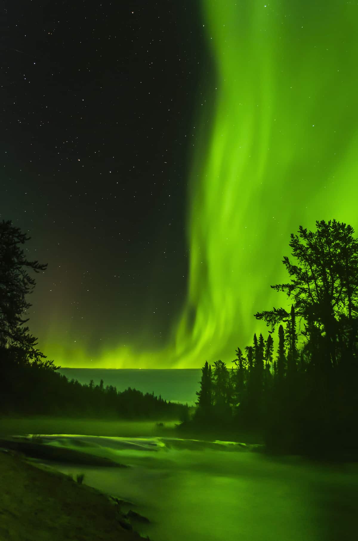 Aurora over Cameron River in Canada’s Northwest Territories