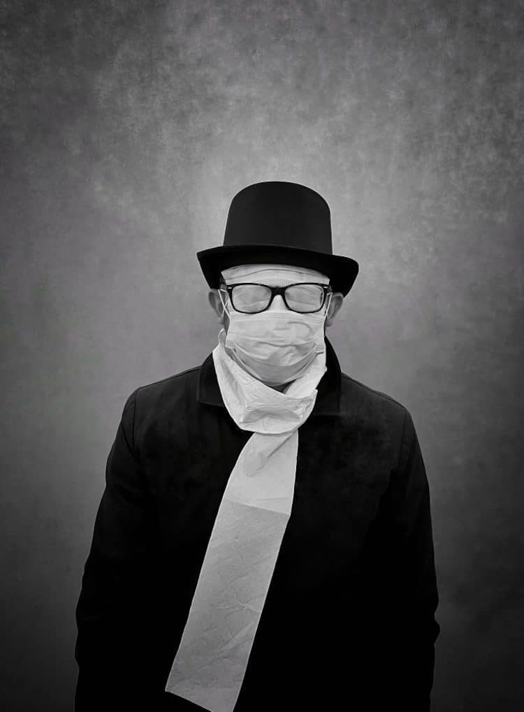 Black and White Photo of a Man Wearing a Surgical Mask