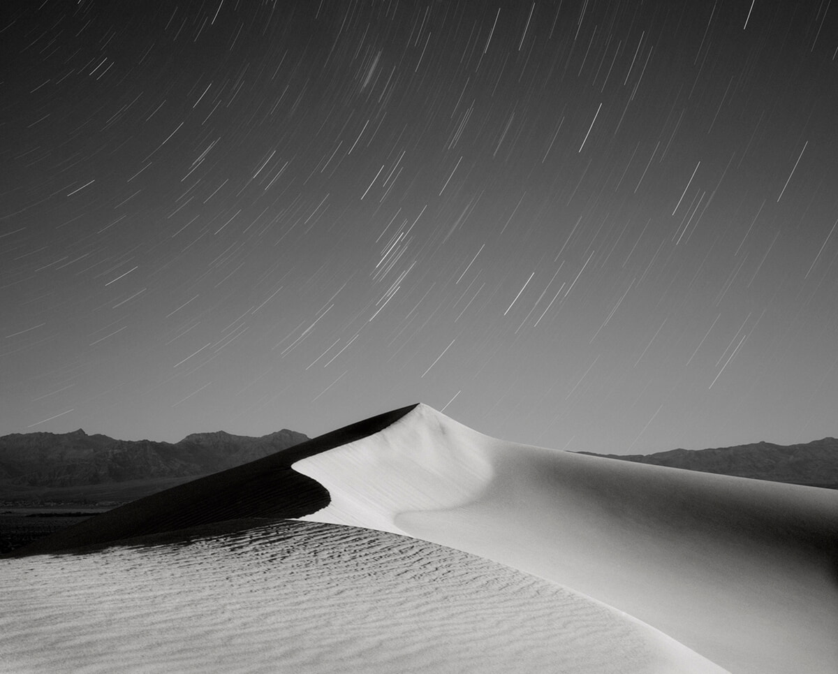 Black and White Desert Landscape with Star Trails