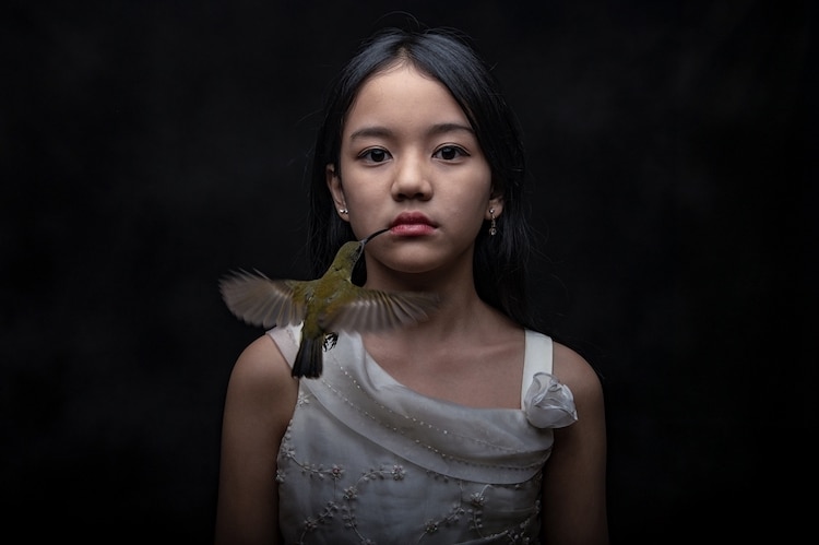 Young Girl Modeling with a Hummingbird Touching Her Lip