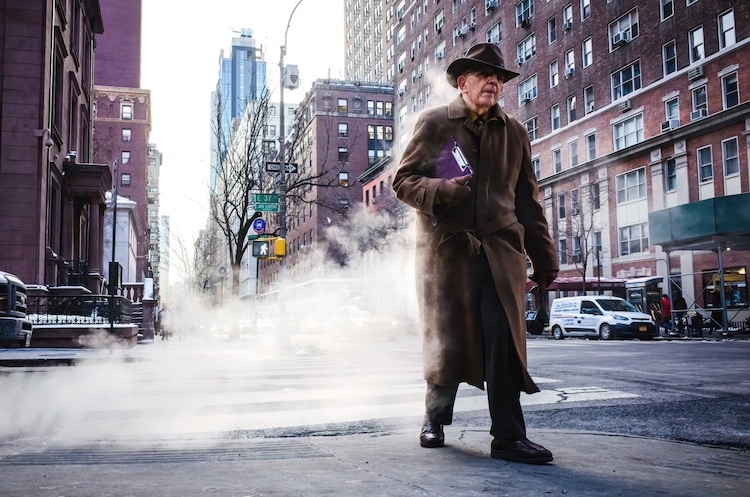 Man in Overcoat Walking by Stream of Steam