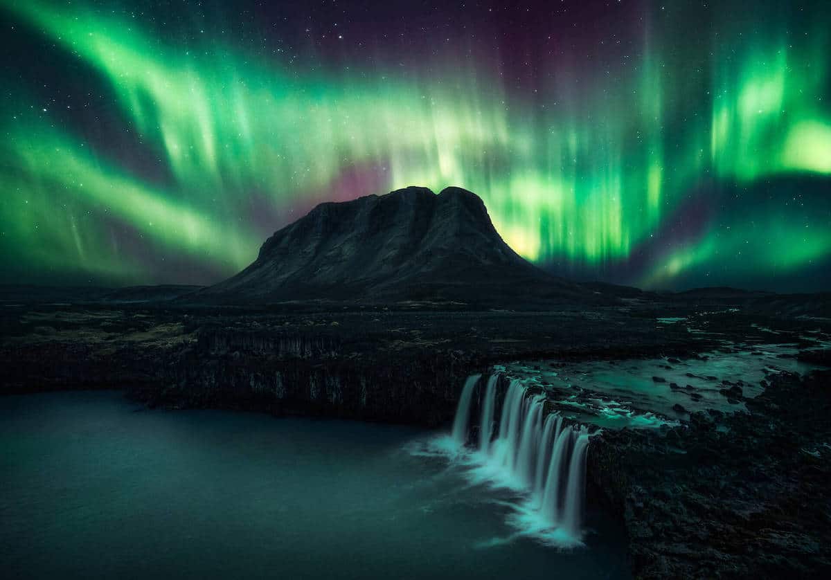 Northern Lights Over Waterfall in Suðurland, Iceland