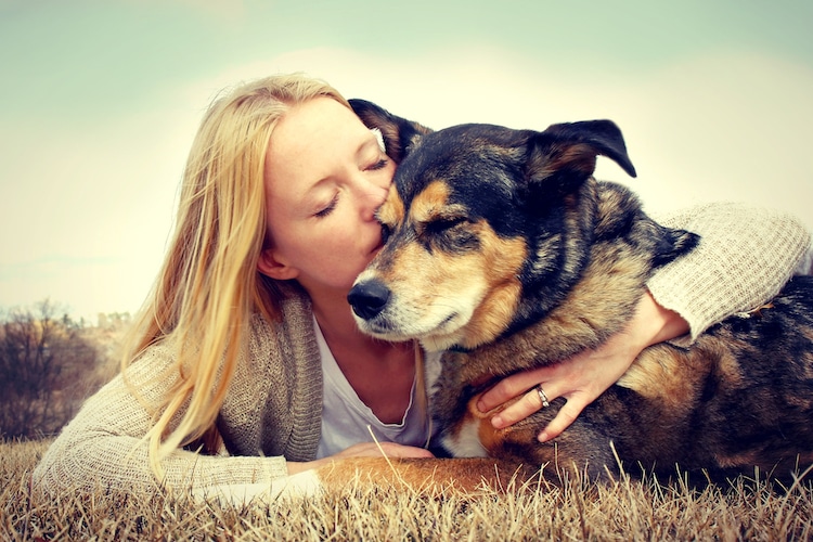 Woman Tenderly Hugging and Kissing Pet Dog