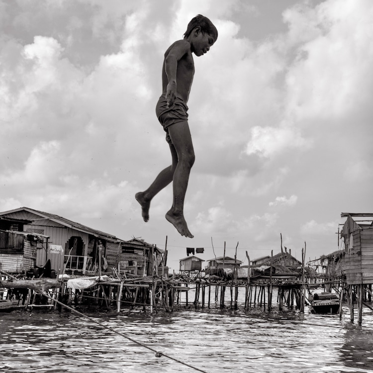 A Sama-Bajau Boy Jumping from His House Into the Sea in Malaysia