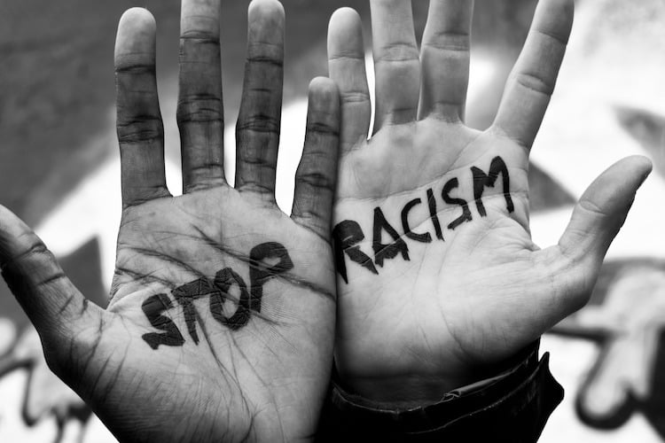 Two Hands with Stop Racism Written on Them