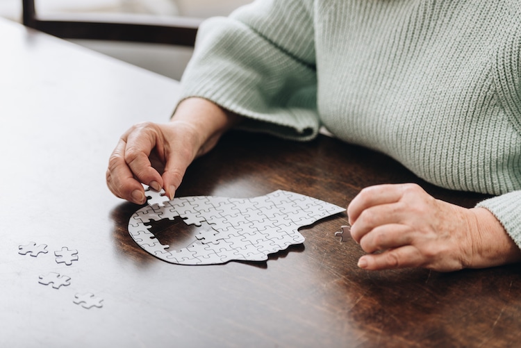 person working on puzzle of human head