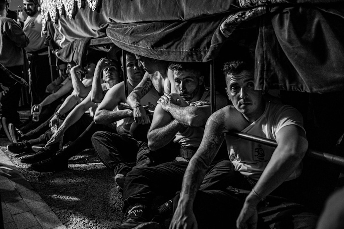 Men Resting During Traditional Easter Procession in Andalusia, Spain