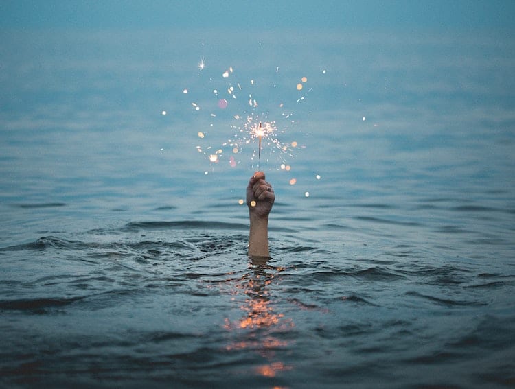 Hand in Water Holding Sparkler