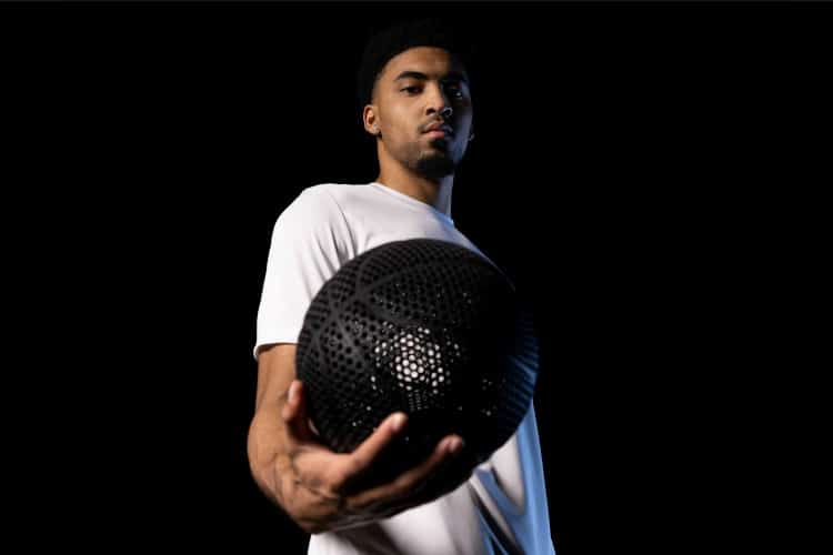 NBA Player KJ Martin fiercely holds the prototype for the Wilson Airless Basketball