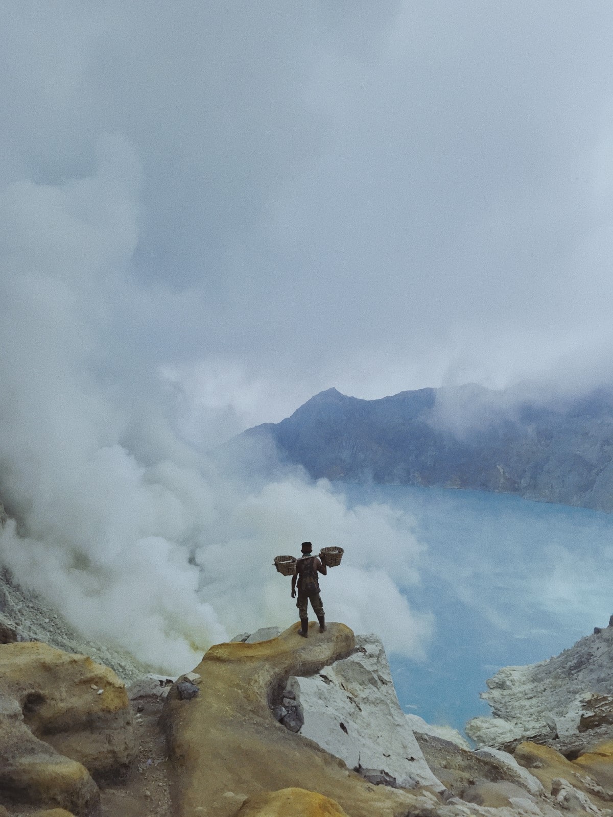 Miner Standing on Cliff at Ijen Volcano