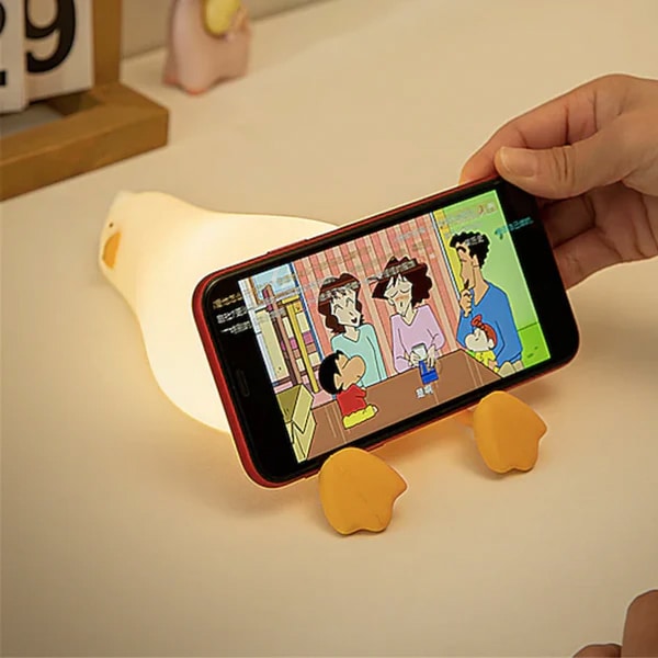 Existential Crisis Duck Night Light being used as a phone stand