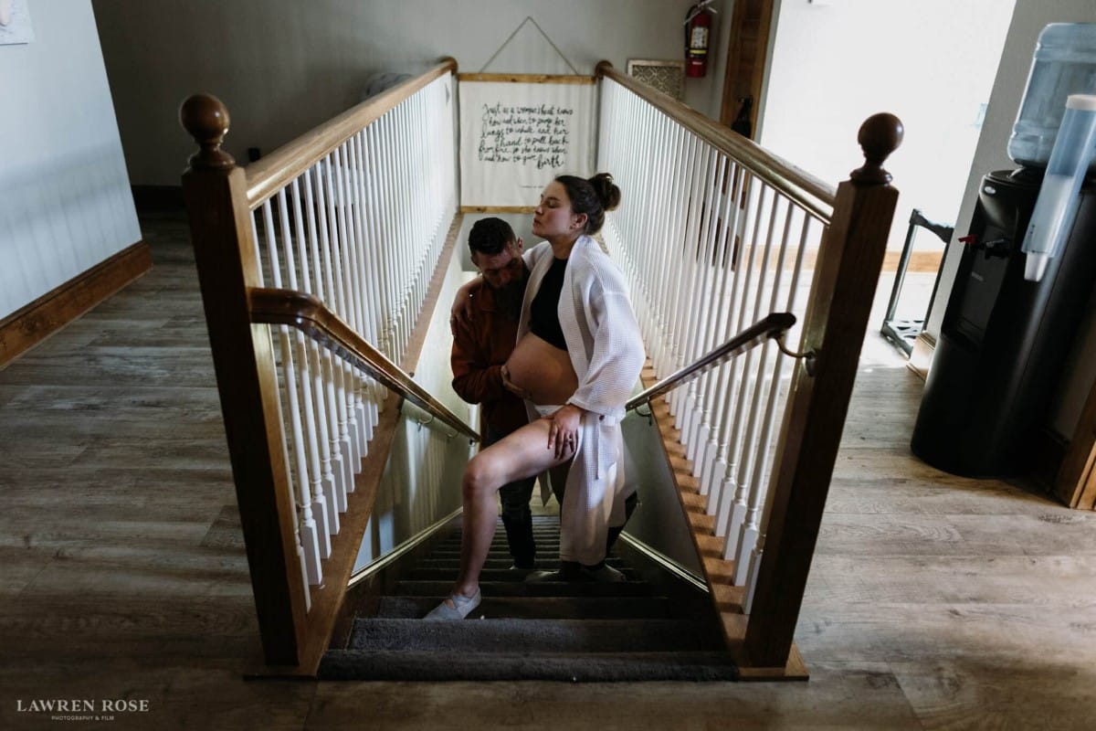 Woman standing on stairs while in labor at birthing center