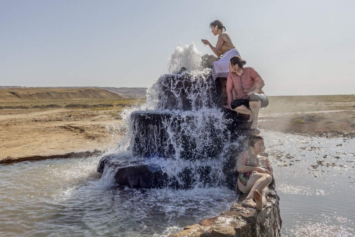 Women visit a hot spring that has emerged from the dried bed of the Aral Sea