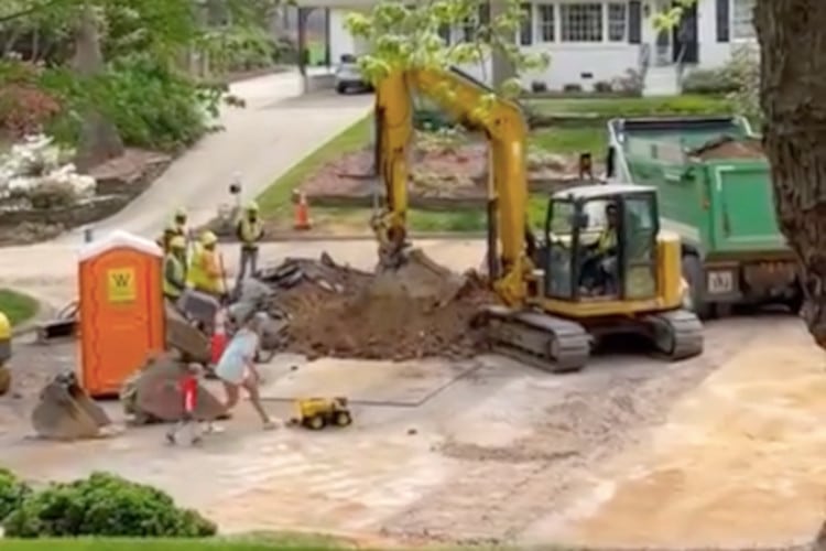Screenshots of video showing Construction Workers Filling a kid's Toy Truck With Dirt From an Excavator in a tree-lined street