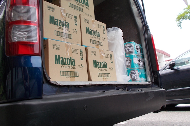 Car trunk full of groceries including Mazzola oil boxes