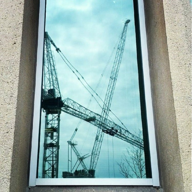 Construction cranes in a window in Toronto