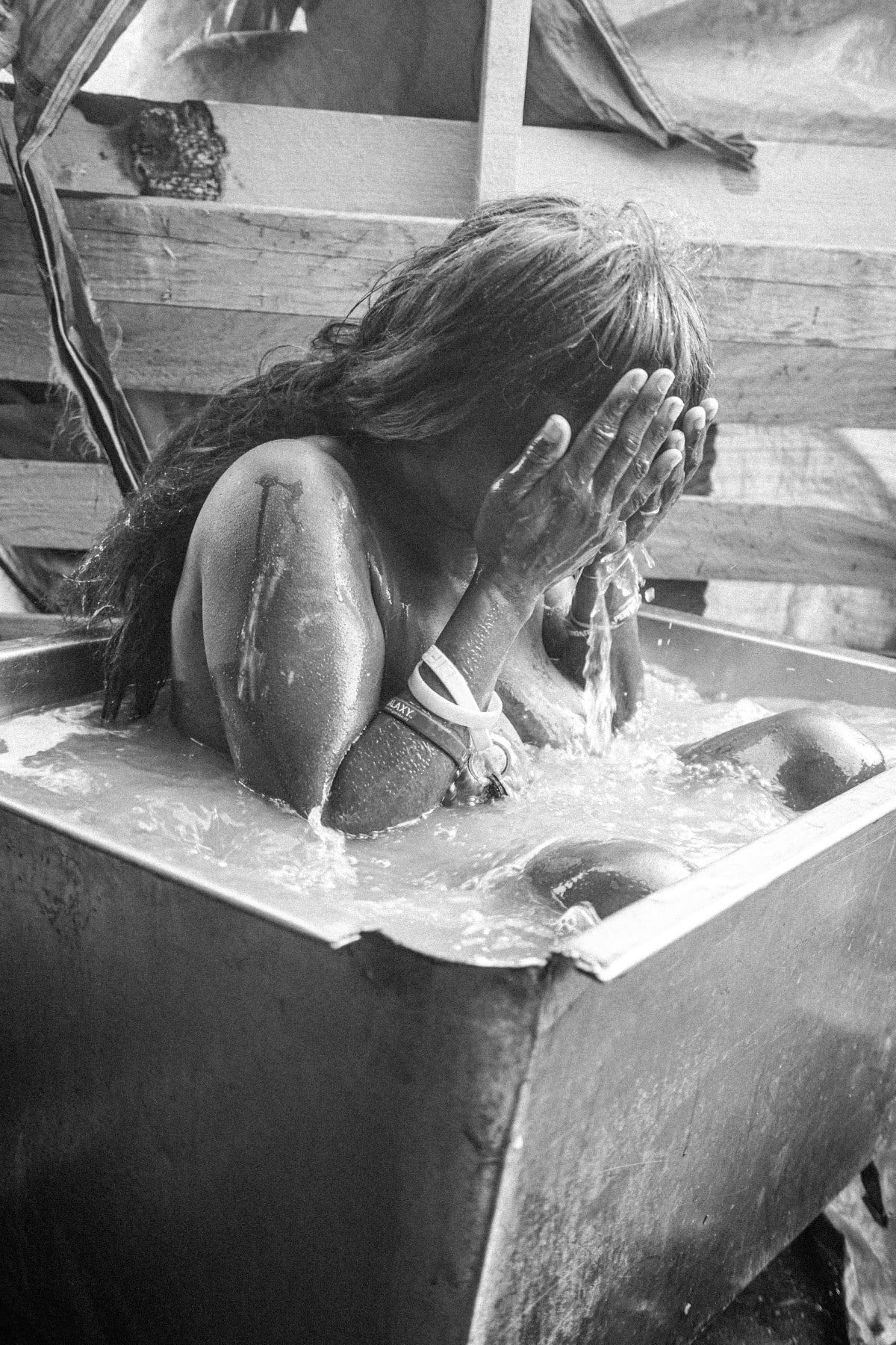 Woman bathing in a tub on Skid Row