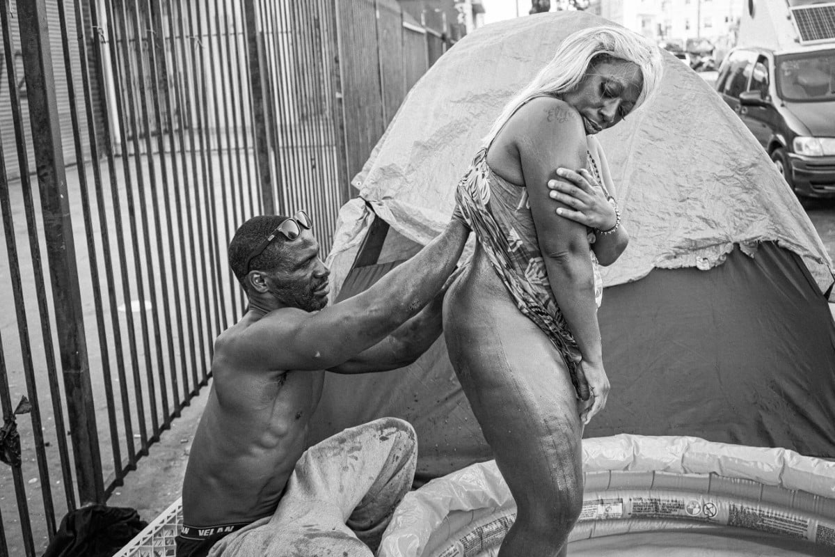 Man bathing woman on Skid Row