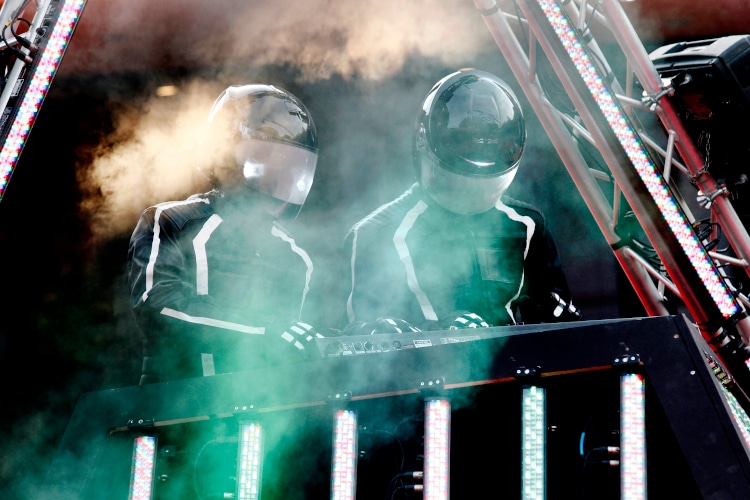 Daft Punk performing live in a smoke-covered stage