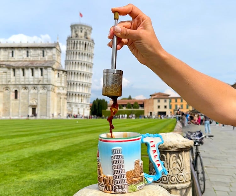 The FinalPress french press being used to make coffee in a cup with the Leaning Tower of Pisa in the background