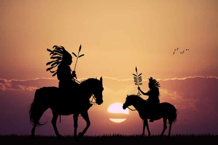 Native Americans on Horses in Silhouette at Sunset