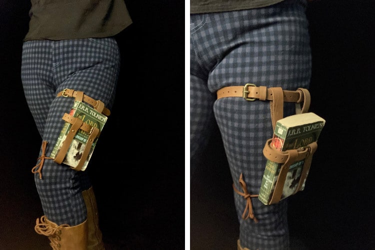 Leather thigh book holster being worn by person with blue pants