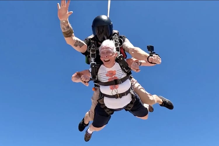 Senior woman and instructor skydiving