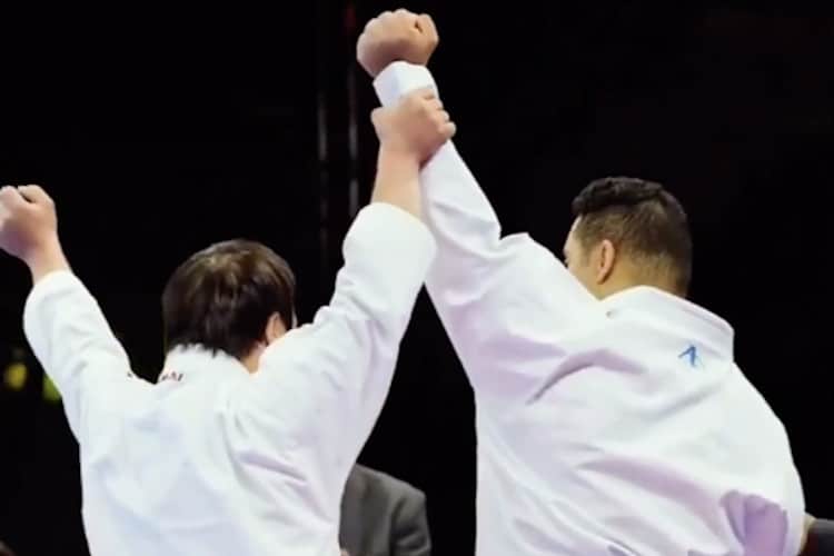 Screenshot of video showing para-karate athlete raising his opponents' hand after defeating him