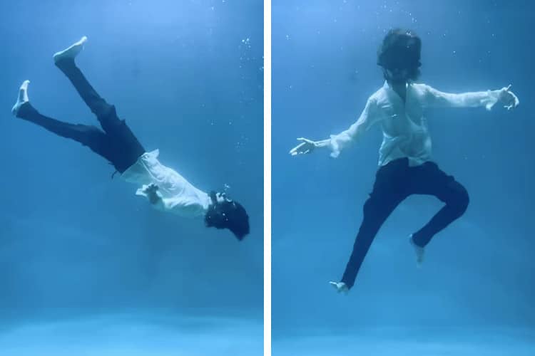 Underwater dancer walking upwards and posing