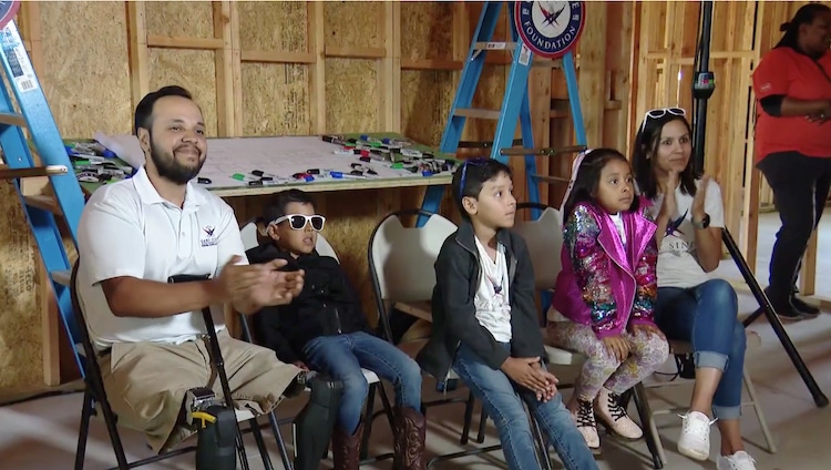 Jose Armenta with his family at their new house being built by the Gary Sinise Foundation