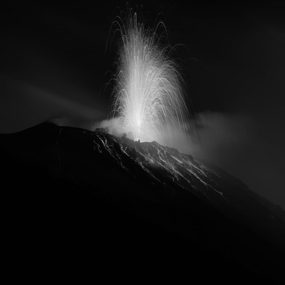 Black and white photo of lava spurting from a volcano