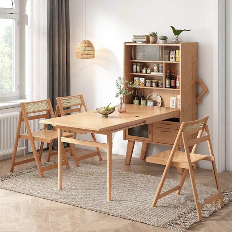 Wooden sideboard that holds a foldout table with chairs