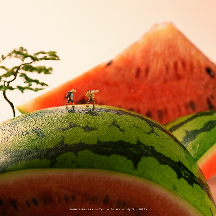 a watermelon doubles as a mountain with hikers