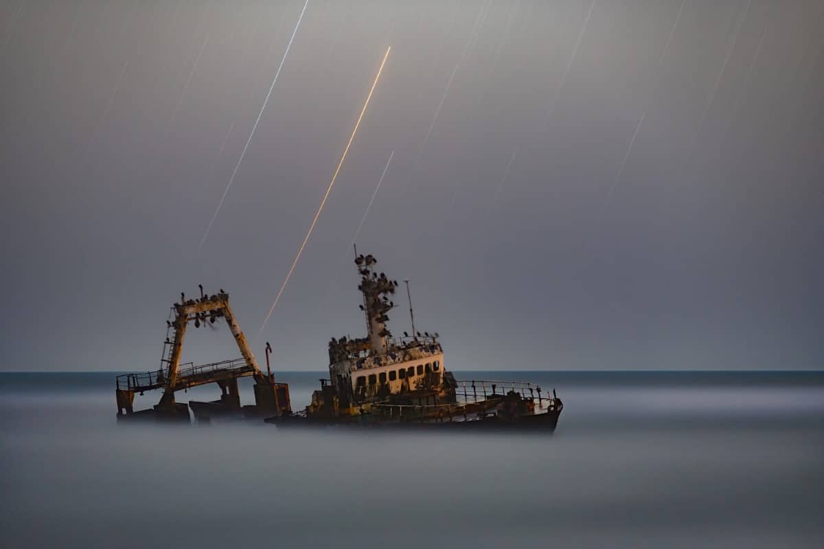 Stars in Namibia behind a shipwreck in the Atlantic