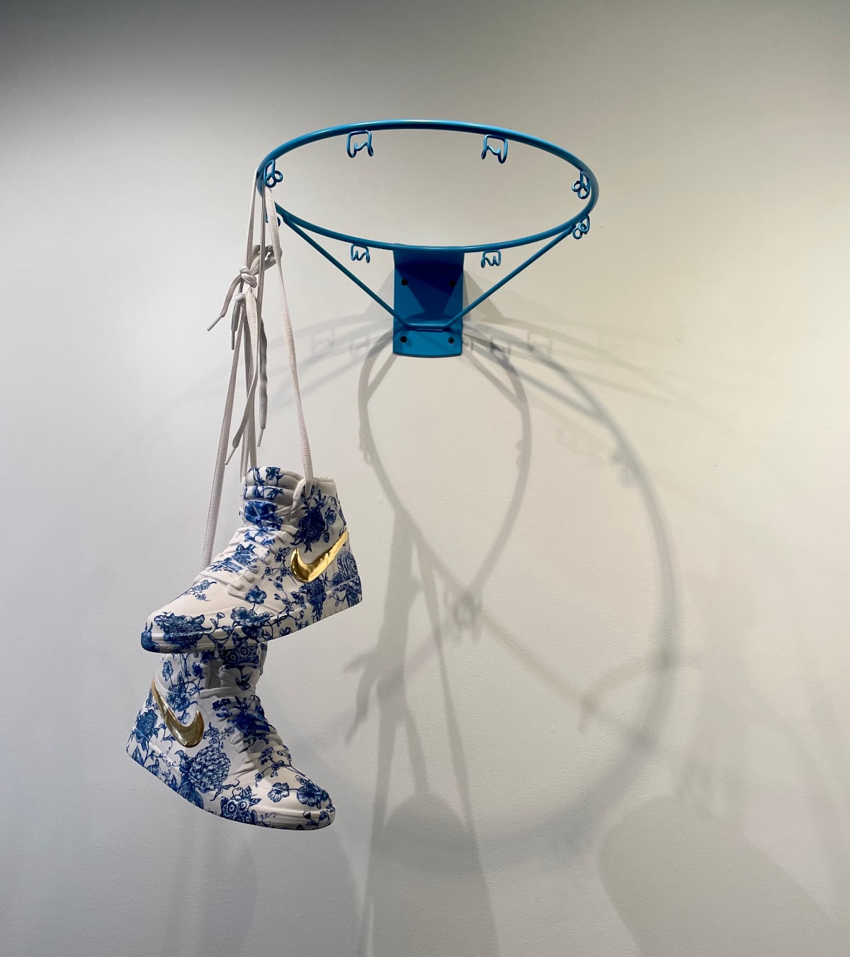 Sneakers and basketball hoop made of porcelain by Brock DeBoer