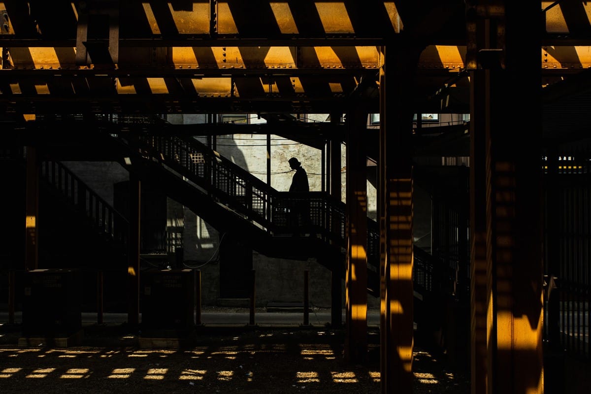 Image of a commuter taking the stairs to catch the subway in Chicago