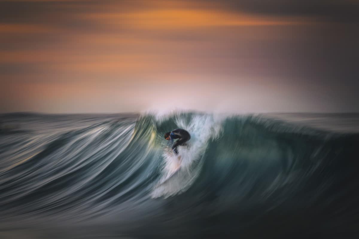 Surfer on a swell in Sydney during sunset